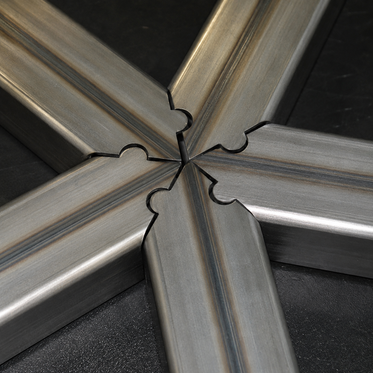 Close-up of a cut steel tube connection on a stair or railing fabrication job.